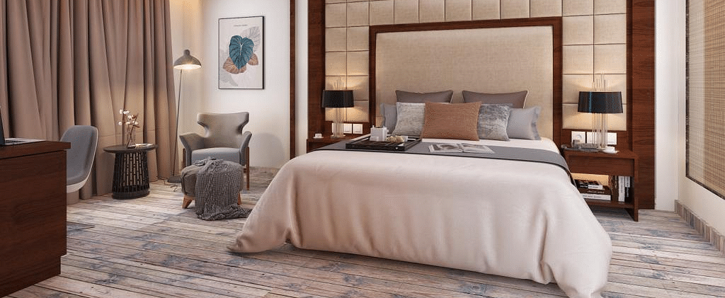 Suite with a king size bed and lamps on each side of the bed at BluSalzz Residence, Amritsar.